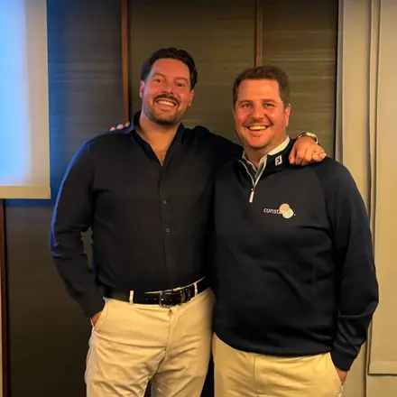Alex and Brad, the co-founders of Constancia, standing together and smiling